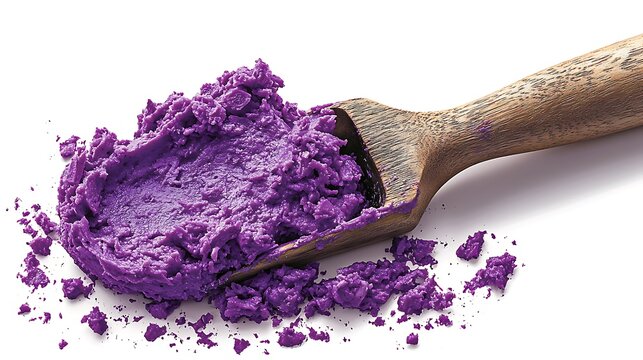 Close-up of vibrant purple ube halaya on a wooden scoop, isolated on white background.
