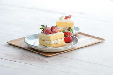 Japanese shortcake with strawberries on top is placed on a white wooden floor