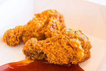 Hot and Spicy Fried Chicken Legs Paired with Crispy Golden Fries for a Perfect Fast Food Treat