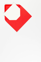 Top view of red envelopes, white card on white background. Post flat lay. Copy space.