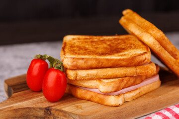 Scrumptious Cheese and Ham Sandwiches with Fresh Tomatoes on a Concrete Table