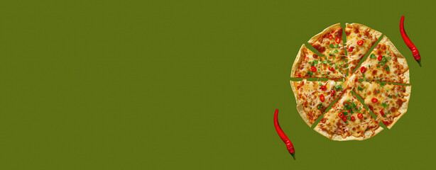 Pizza slices with chili peppers on green background offering ample copy space for text or designs