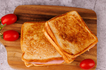 Savory Cheese and Ham Sandwiches with Cherry Tomatoes on a Black Concrete Table