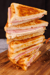 Appetizing Tower of Ham and Cheese Sandwiches on a Gray Concrete Surface