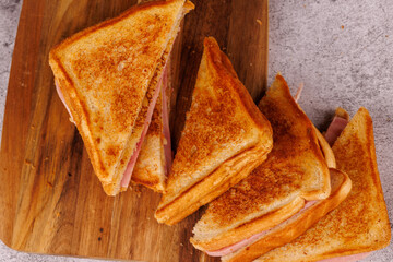 Delicious Ham and Cheese Sandwiches in a Vertical Arrangement on a Dark Surface