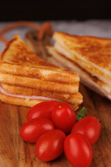 Tasty Ham and Cheese Sandwich with Cherry Tomatoes on a Gray Concrete Table