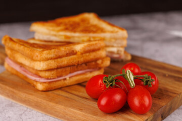 Tempting Ham and Cheese Sandwich with Cherry Tomatoes on a Gray Table