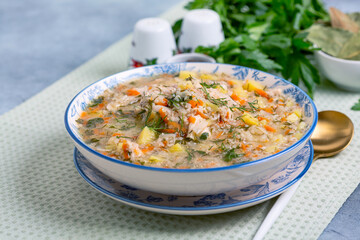 Chicken and vegetable soup with barley groats.