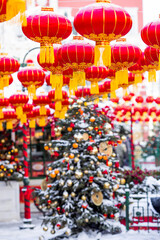 Fototapeta premium Chinese red Christmas lanterns on Tverskaya Street in Moscow. Close-up. The first ever meeting of the Chinese New Year 2024 in Moscow.