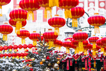 Fototapeta premium Chinese red Christmas lanterns on Tverskaya Street in Moscow. Close-up. The first ever meeting of the Chinese New Year 2024 in Moscow.