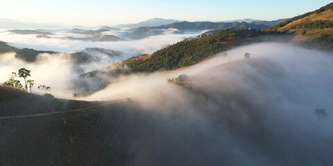 Obraz premium Aerial landscape view of the sea of fog flowing on hills