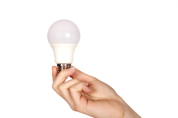 Female hand holding LED lamp with metal base on white background.