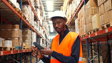 Warehouse worker scanning packages with barcode scanner - Powered by Adobe