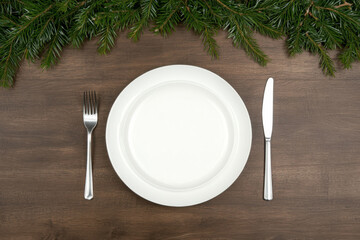 A plate with a fork and knife on a wooden table