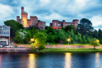 Fototapeta premium Scotland - Inverness skyline with castle reflection in Ness river at dramatic sunset, UK