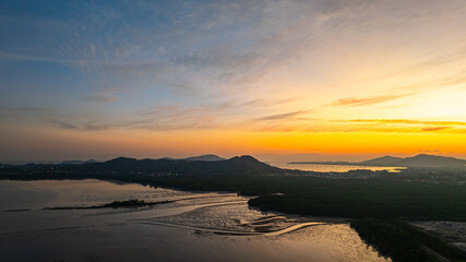 A stunning panoramic view of a coastal city at sunset at Phuket city, showcasing vibrant hues of...