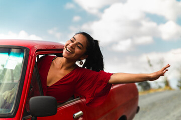 Happy woman looking out of car window