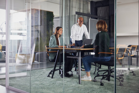Co workers having meeting in cabin at office