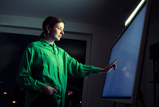 Woman touching digital screen at office