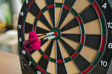 Bulls eye hit with three darts precisely in the target center spot