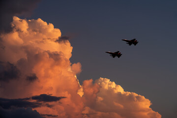 Army Show performant of aircraft in air show with twilight sky background.	