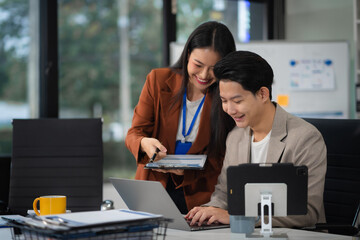 Business team working on a project in the office or reviewing and discussing a business project.