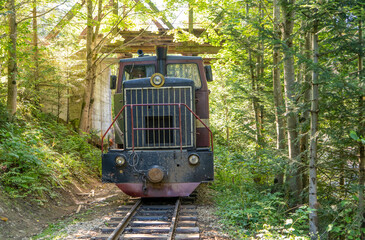 Carpathian tram. Steam locomotive on a narrow-gauge railway. Old transport in green forest nature