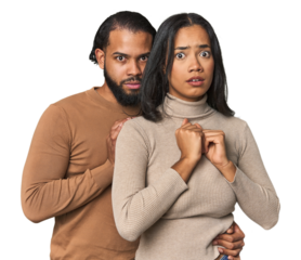 Young Latino couple in studio scared and afraid.