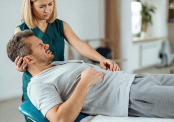 Obraz premium Physical Therapist Examining Patient with Abdominal Pain
