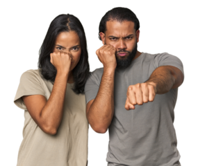 Young Latino couple in studio throwing a punch, anger, fighting due to an argument, boxing.