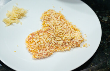 Tenderized meat in breadcrumbs, raw turkey breast fillet pieces ready for cooking, homemade schnitzel