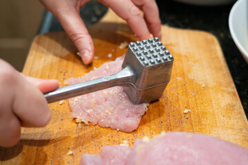 Tenderize meat, beating, hammering fillet pieces, cooking schnitzel process closeup