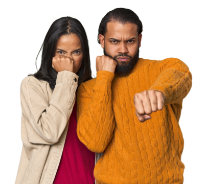 Young Latino couple in studio throwing a punch, anger, fighting due to an argument, boxing.