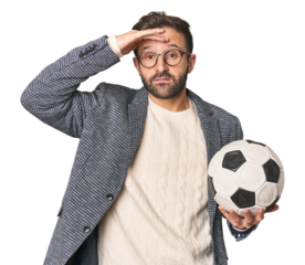 Hispanic male soccer coach in studio being shocked, she has remembered important meeting.