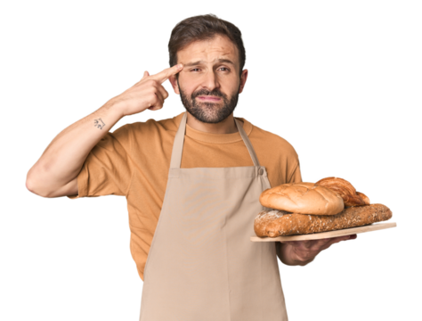 Hispanic male baker with bread tray showing a disappointment gesture with forefinger.