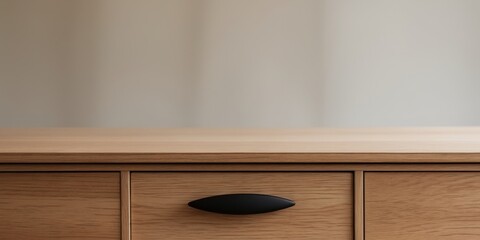 A wooden desk with a black handle on the top