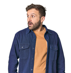 Fototapeta premium Studio portrait of young Hispanic male being shocked because of something she has seen.