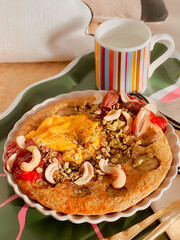  Healthy banana oatmeal pancakes with sunny side up egg with mixed seeds. Simple brunch menu. Morning time. Delicious food. Scandinavian style. Homemade food. Cooking recipes. Breakfast tray. Bedroom.