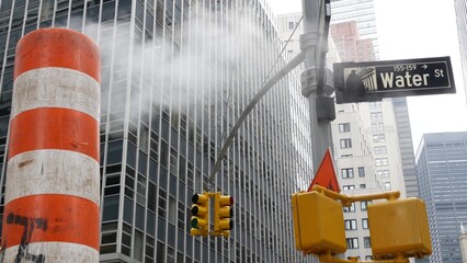 Steam vapor vented on New York City Water street, orange vapour tube stack. Hot smoke from pipe....