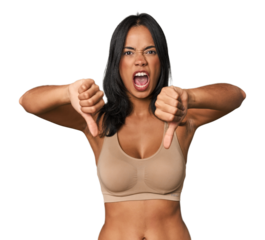 Young Filipino woman in light wear  showing thumb down and expressing dislike.