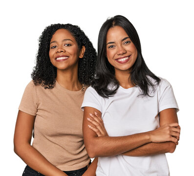 Young Latin friends in studio who feels confident, crossing arms with determination.