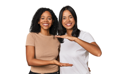 Young Latin friends in studio holding something with both hands, product presentation.