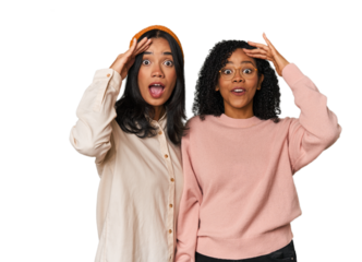 Young Latin friends together in studio shouts loud, keeps eyes opened and hands tense.