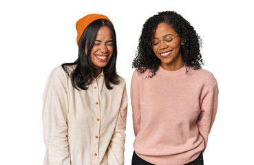 Young Latin friends together in studio laughs and closes eyes, feels relaxed and happy.