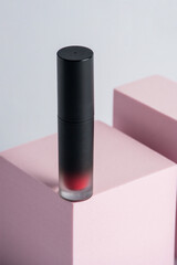 Obraz premium Mockup of black blank thin tube - mascara, lip gloss, gel, eyeliner, oil, etc. Cosmetic package with stylish props on white background. 