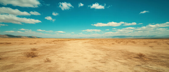 Expansive desert landscape with vast rolling sand dunes under a bright blue sky
