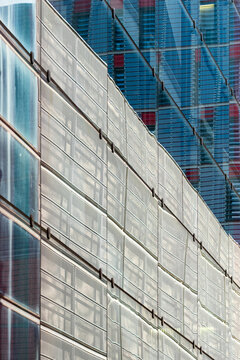 The image captures glossy surfaces in urban architecture, showcasing intricate details and textures that create a harmonious blend of modern design and functionality.