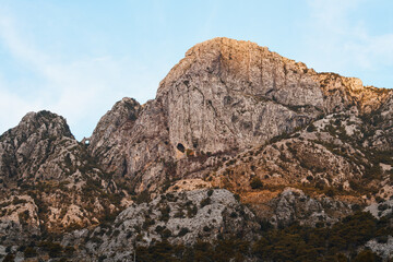 Sunlit mountains by calm lake scene