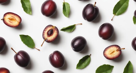 Fresh plums with green leaves on white. Food background. Top view
