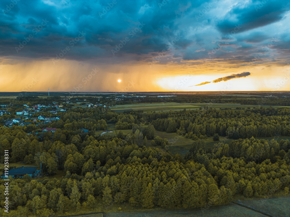 Poster Storm clouds and sunset sky above countryside village